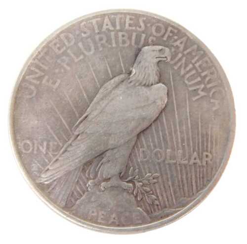 Coins. A United States of America silver dollar, peace eagle emblem, 1922.