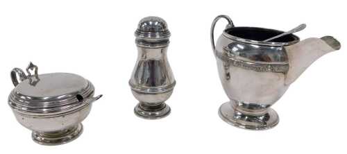 An Elizabeth II three piece silver cruet set, comprising pepper pot, of inverted circular form,...