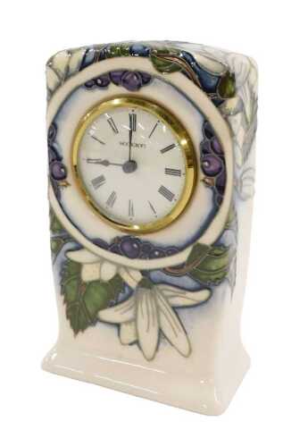 A Moorcroft pottery Juneberry pattern mantel clock, no. 362, 17cm high, boxed.