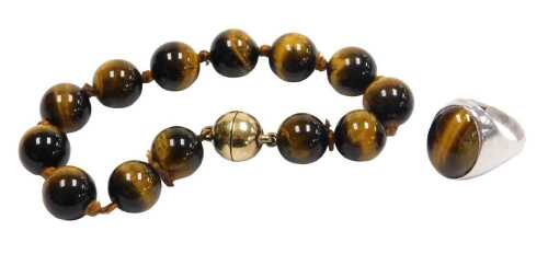 Two items of tiger's eye jewellery, comprising a moulded bead bracelet, with silver gilt clasp...