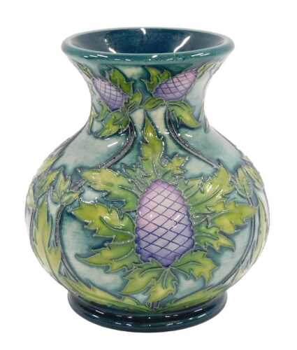 A Moorcroft pottery vase, 11cm high, boxed.