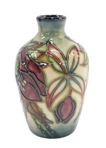 A Moorcroft pottery Hellebore pattern vase, 12cm high, boxed.