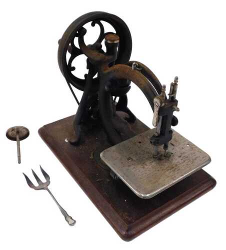 A very early 20thC Willcox and Gibbs cast iron sewing machine, with chrome plate, articulated...