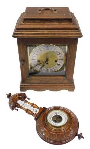An early 20thC oak cased mantel clock, with 17cm diameter arched dial with silvered Roman...