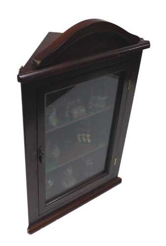 A small hanging corner cupboard, containing a quantity of lead type miniature soldiers in...