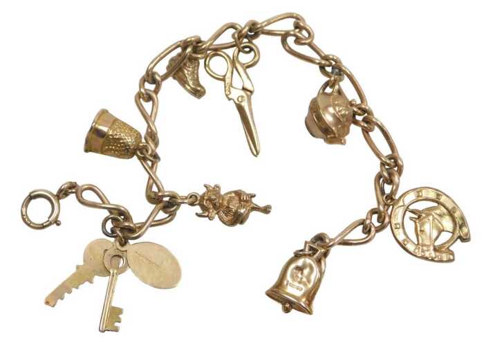 A 9ct gold figaro link charm bracelet, with assortment of charms, to include bell, horses head,...