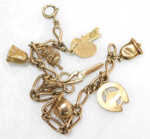 A 9ct gold figaro link charm bracelet, with assortment of charms, to include bell, horses head,... - 2