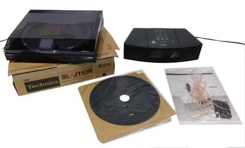 A Bose Wave radio/CD, AWRC type, with wire, associated ephemera and remote control, and a...