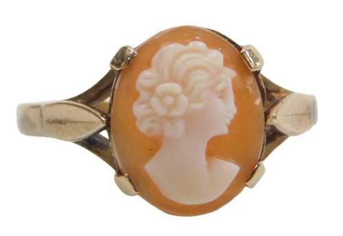 A 9ct gold shell cameo dress ring, the oval cameo with raised relief figure of a female looking...