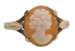 A 9ct gold shell cameo dress ring, the oval cameo with raised relief figure of a female looking...
