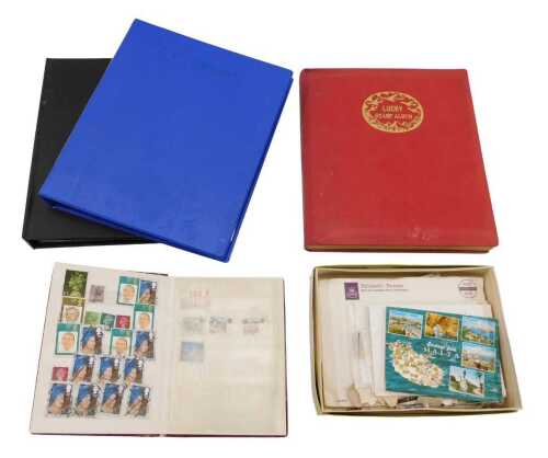 Various stamps, a stamp album in red with gilt trim containing a small quantity of GB collectors...