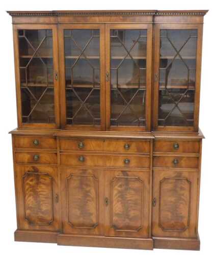 A 20thC mahogany breakfront bookcase, with a fixed dentil top raised above four astragal glazed...