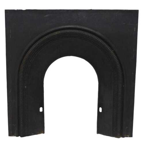 A late Victorian cast iron fire insert, of arched form, with a bell flower style decoration, overall 106cm high, 103cm wide, with 45cm wide gap.