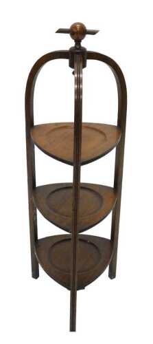 A mid 20thC Art Deco oak fixed three sectional cake stand, with orb top, 88cm high.