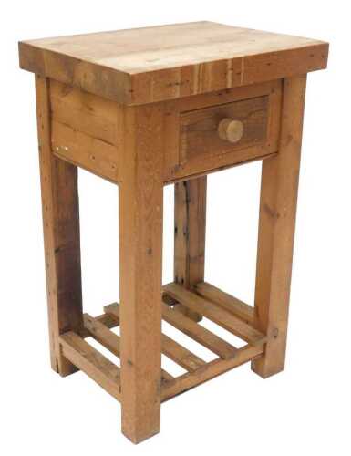 A pine butcher's block open cabinet, the rectangular top raised above a heavy frieze drawer, on...