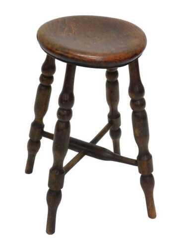 A 19thC elm stool, with shaped oval top, raised on turned legs joined by an X stretcher, 53cm...