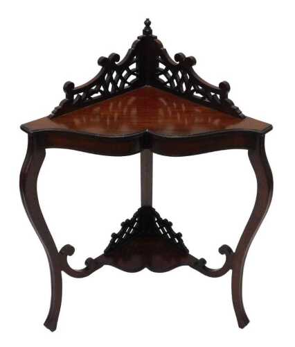 An Edwardian corner stand, with two part pierced galleried top, raised above shaped section and...