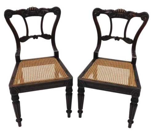 A pair of dining chairs by Gillows of Lancaster, circa 1825, with heavily carved scroll cresting...