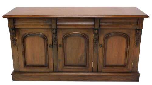A principally Victorian mahogany sideboard, the rectangular top raised above three arched...