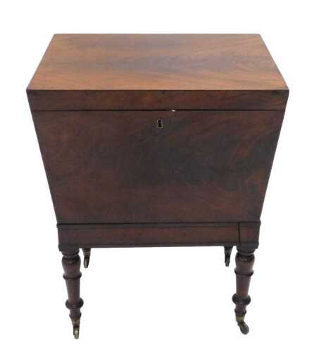 An early 19thC mahogany teapoy or cellarette, the hinged lid revealing a fitted interior with...