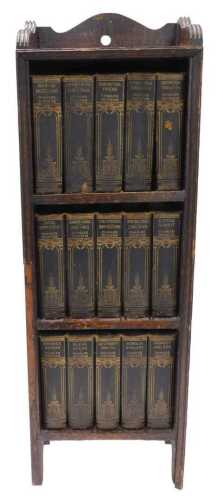 An oak narrow bookcase containing various Charles Dickens classics, to include Barnaby Rudge,...