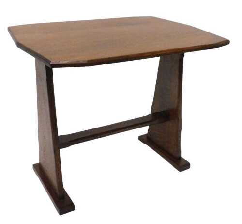 A 20thC oak Arts and Crafts style coffee table, the shaped top on tapering stiles joined by a...
