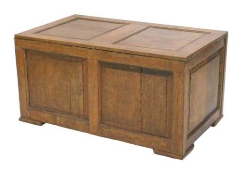 A 19thC oak two panelled coffer, of plain rectangular form, on compressed feet terminating in...