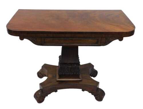 An early 19thC flame mahogany card table, with baize lined interior, on a heavily carved acanthus leaf stem, terminating in an inverted platform base with scroll feet, when closed 71cm high, 93cm wide, 46cm deep.