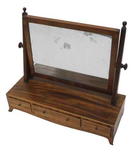 A 19thC mahogany table mirror, the rectangular glass held by fluted stiles, surmounted by orb...