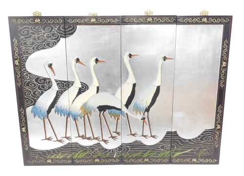 A set of four Japanese wall panels, making a scene of cranes, each of rectangular form, with...
