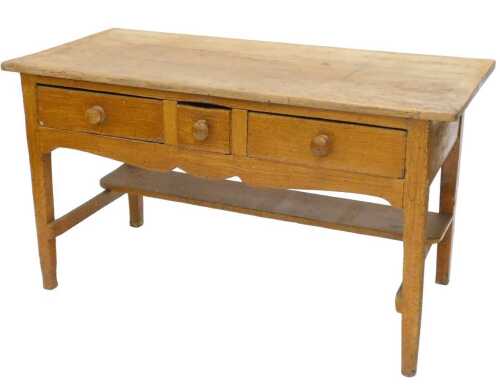 A 19thC pine kitchen side table, the oblong top raised above three frieze drawers, on square...