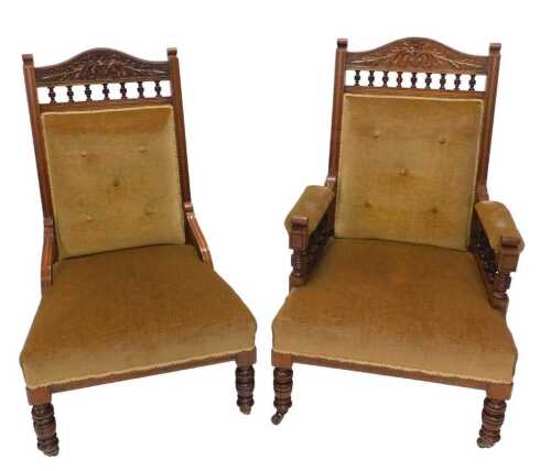 A pair of Edwardian walnut ladies and gentlemans showframe arm and open chairs, each with studded overstuffed backs and deep seats, on turned front legs terminating in castors, 102cm high.