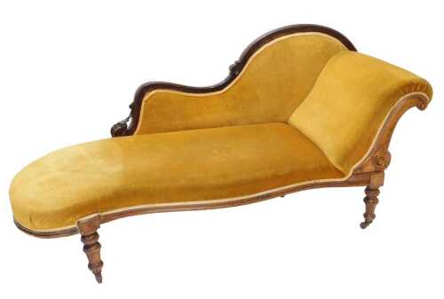 A late 19thC walnut framed chaise longue, with shaped carved back, arched arm, and serpentine...