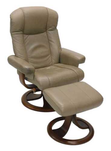 A Ekornes Stressless style leather armchair and separate footstool, each on wooden circular...