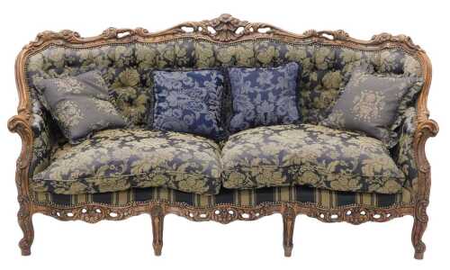 A heavily carved Victorian style three seater sofa, with floral and scroll frame, on cabriole...