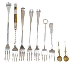Nine various silver pickle forks and other serving items, two silver gilt miniature spoons,...