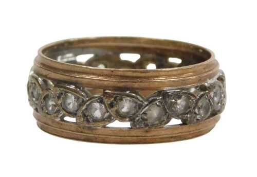 An eternity band, with leaf design set with CZ stones, on white metal centre on a yellow metal...