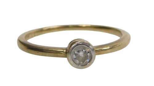A 9ct gold single stone dress ring, set with CZ in a raised rub over setting with white metal...