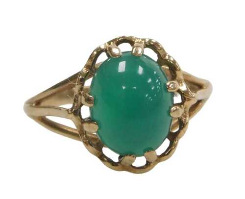 A 9ct gold dress ring, with oval cabochon jade, in raised flower and claw setting, ring size N&frac12;,...