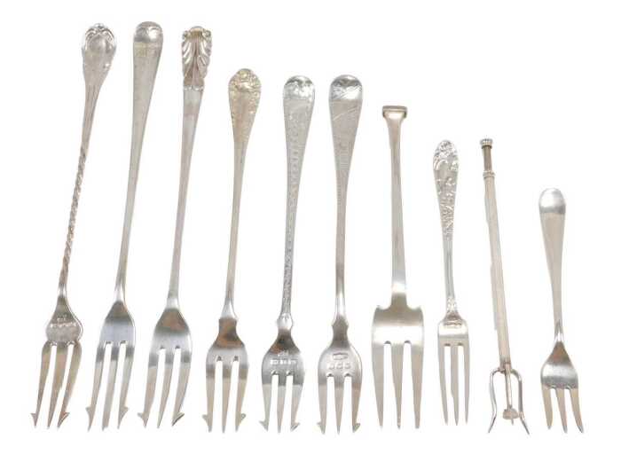 Ten pickle forks, to include a three pronged example with bright cut Old English pattern stem,...