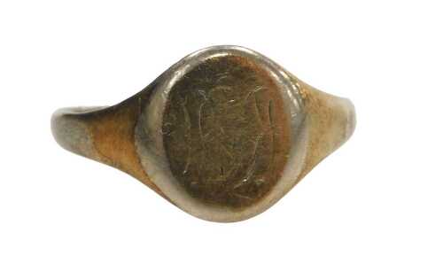 A gentlemen's signet ring, with a rubbed oval face bearing part initials stamped 9ct on sil,...