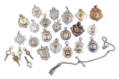 A quantity of silver fobs, for winners crests and shields, and an assortment of watch keys, the...