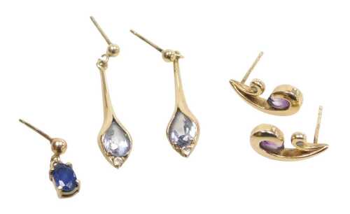 Two pairs of lady's earrings, comprising a pair of amethyst and cz swirl studs, 1.5cm high,...