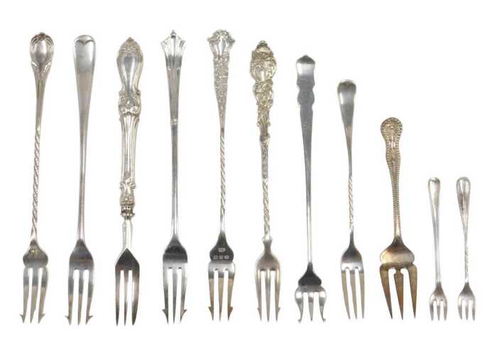 Eleven pickle and other serving forks, to include a small Old English pattern, with entwined...