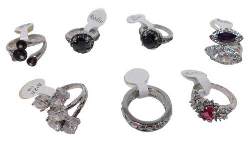 Seven dress rings, each stone set, varying from size 17 to 19, each on a white metal coloured...