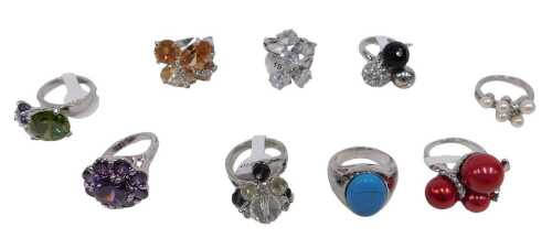 Nine dress rings, each stone set, varying from size 17 to 19, each on a white metal coloured...