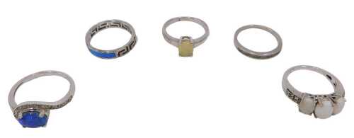 Five dress rings, each white metal and stone set, to include mainly opal, and a half hoop cz...