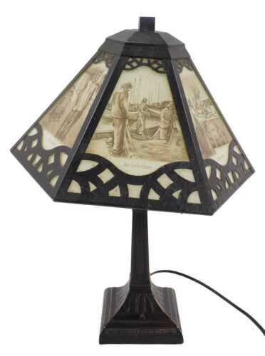 A decorative metal table lamp, with various professions printed to the shade, to include The...