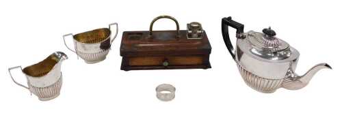 A silver plated three piece tea service, comprising teapot of cape form with angular thumb mould...