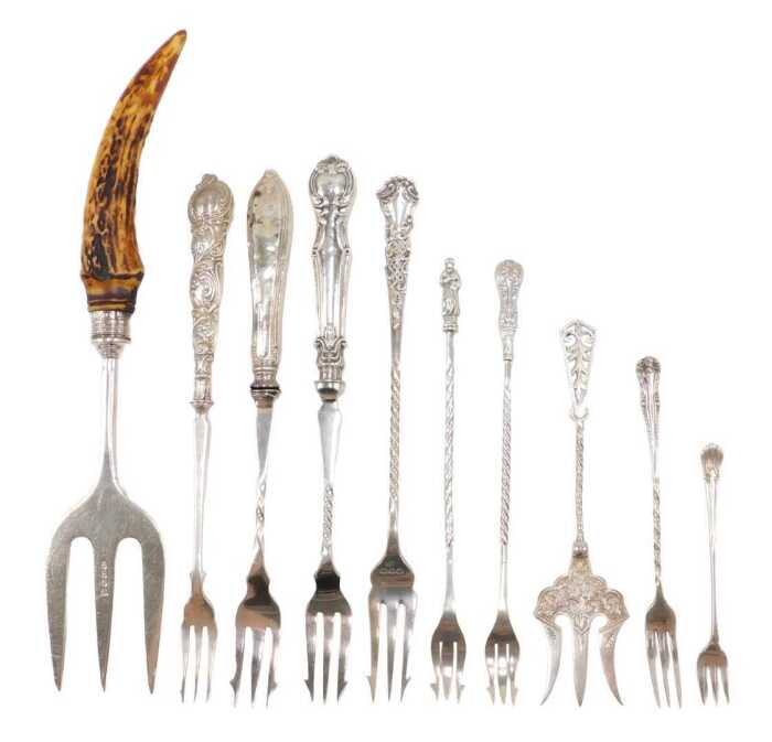 Ten silver and other pickle and serving forks, to include a horn handle example, with silver...